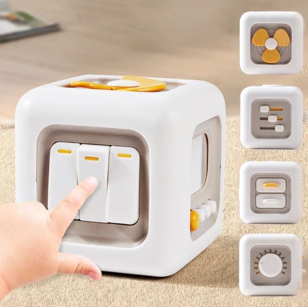 Cube sensoriel montessori interactif avec plusieurs éléments manipulables, y compris des interrupteurs, un ventilateur, des curseurs et des boutons, pour développer la motricité fine des tout-petits.