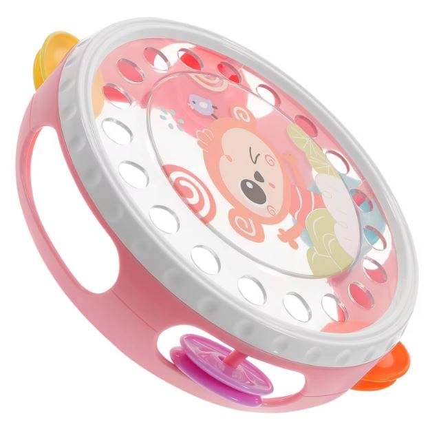 Tambourin pour enfant de couleur rose avec un motif de singe, équipé de petits grelots multicolores pour favoriser l'éveil musical des tout-petits.