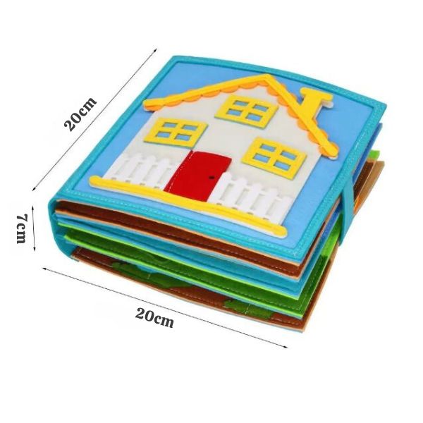 Grand livre d'éveil en tissu mesurant 20 cm de côté et 7 cm d'épaisseur dont la couverture illustre une maison colorée, conçu pour favoriser l'apprentissage et l'éveil des tout-petits.