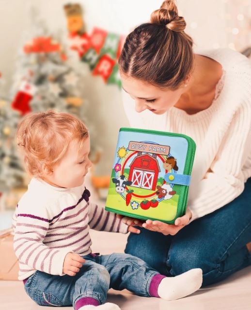 Une mère partage un moment de lecture avec son enfant, explorant un livre d'activités coloré sur le thème de la ferme, idéal pour favoriser le développement cognitif et moteur des tout-petits.