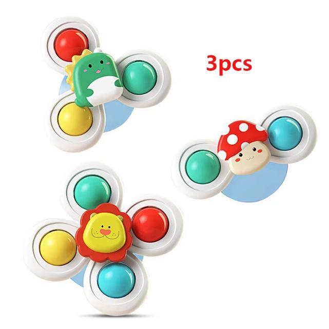 Lot de 3 spinner pour bébé, chacun avec des couleurs vibrantes et des personnages adorables, comme un champignon, un dinosaure et un lion.